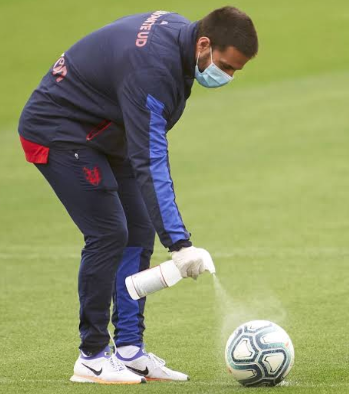 Jose Mourinho: Manchester United officer disinfecting a ball on a training filed 