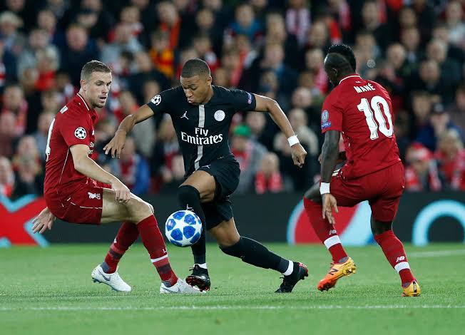 Kylian Mbappe battling it out with Liverpool players 