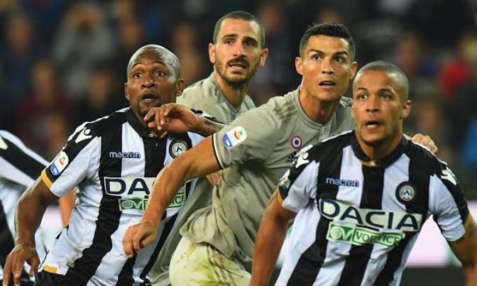 Udinese's William Troost-Ekong defending against Juventus' Cristiano Ronaldo during an Italian Serie A match 