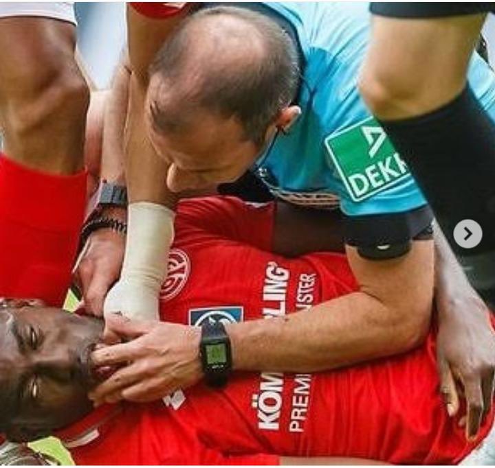 Referee Marco Fritz trying to resuscitate Taiwo Awoniyi