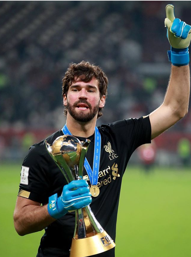 Alisson Becker with the FIFA World Club Cup trophy 