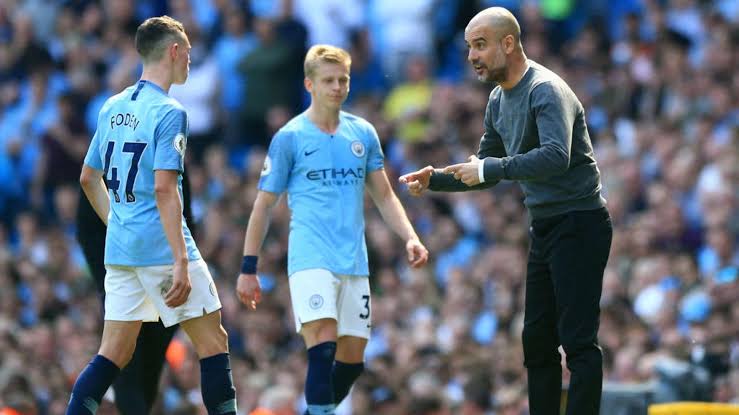 The manager of Manchester City, Pep Guardiola passing instructions to City's Foden 