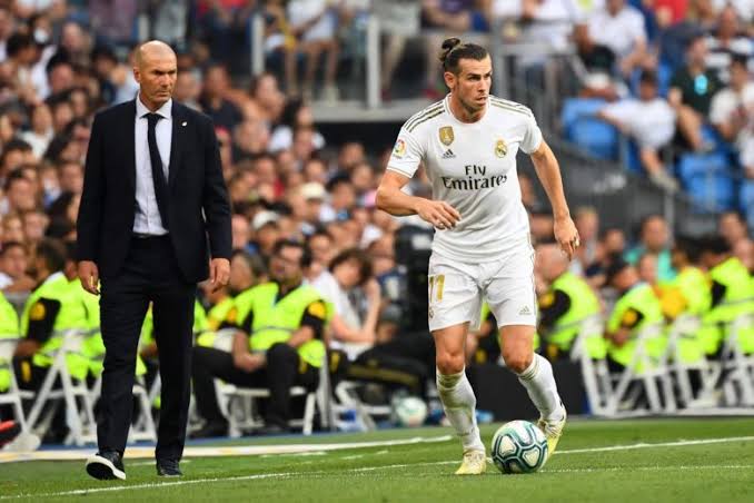 Gareth Bale in action while Madrid's Zinedine Zidane watch closely on the sideline. 