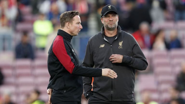 Liverpool assistant manager Pep Lijnders discussing with Jurgen on the touchline 