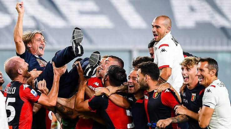 Genoa players celebrating their manager after they survived relegation in Italian Serie A for the second time in two seasons. 