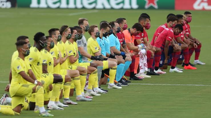 Major League Soccer teams taking a knee before a match.