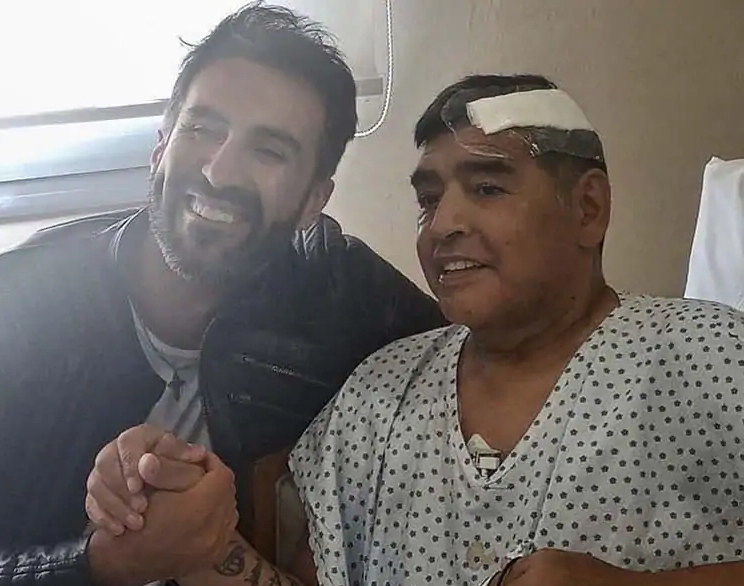Diego Armando Maradona posing with his doctor after successful brain surgery in November 2020.