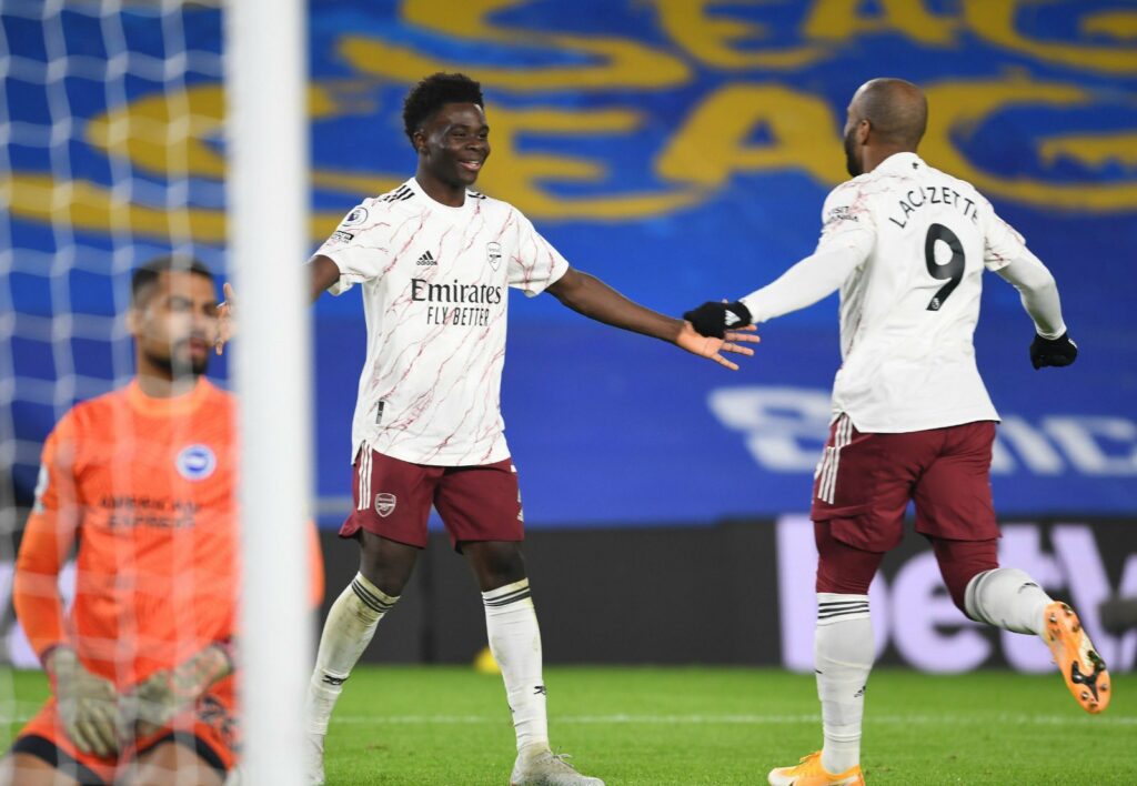 Arsenal's Bukayo Saka celebrates with Alexandre Lacazette after assisting him to score the winning goal against Brighton.