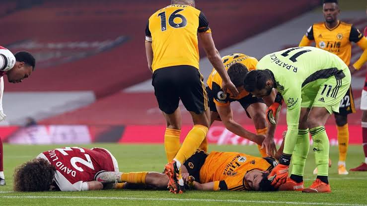 Wolves' Raul Jimenez and Arsenal's David Luiz lying on the pitch after the collision. 