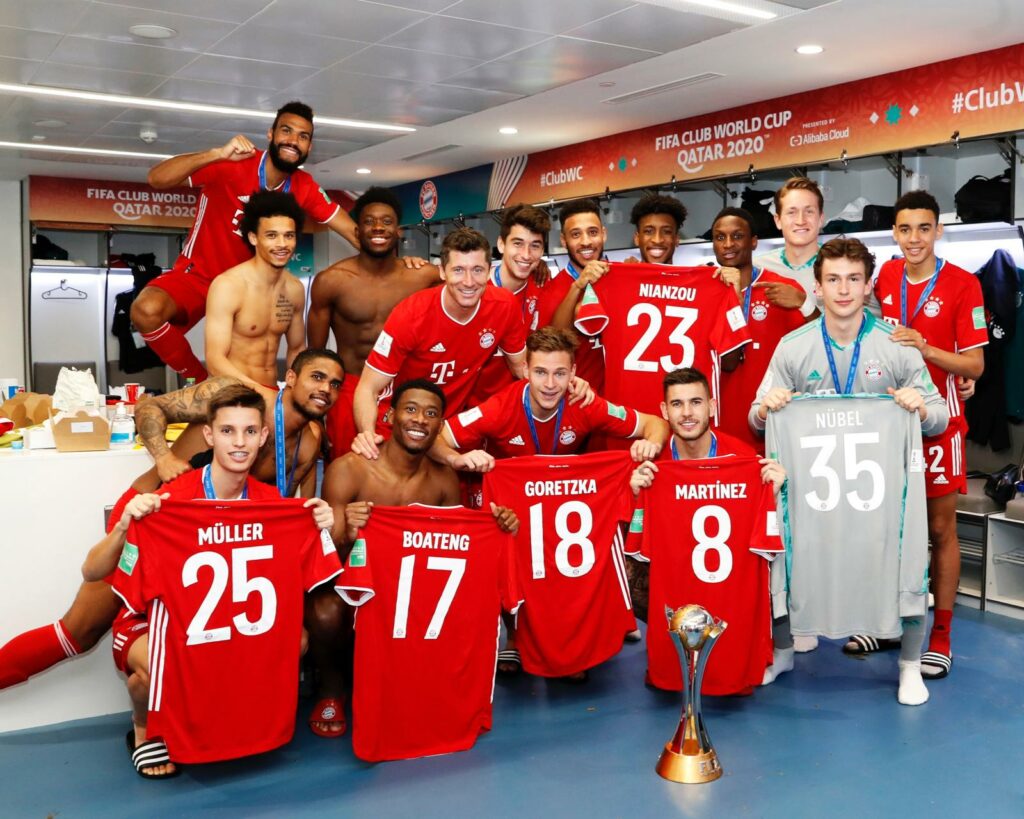 FC Bayern Munich players celebrate with the jerseys of the club's players who were not in Qatar with them. 