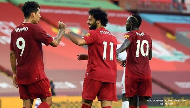 Sadio Mane, Roberto Firmino, and Mohamed Salah celebrate together.
