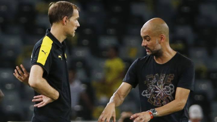 Thomas Tuchel when he was the manager of Borussia Dortmund discussing with Pep Guardiola when he was managing Bayern Munich. 