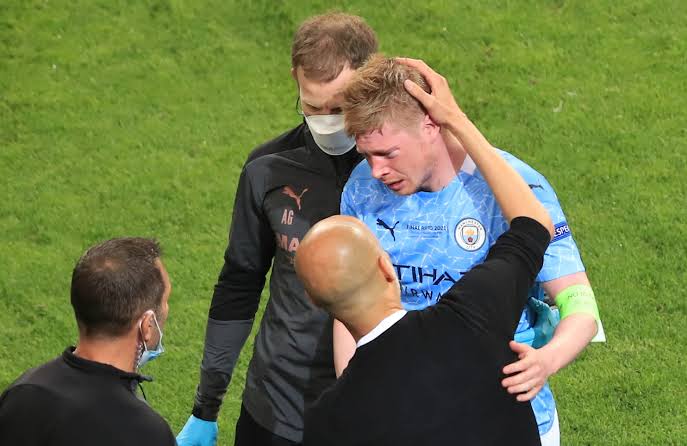 Kevin De Bruyne being checked on after his collision with Chelsea's Antonio Rudiger.