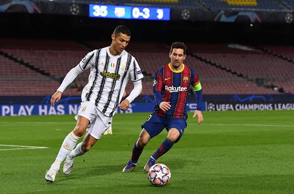 Lionel Messi and Cristiano Ronaldo in a contest during a UEFA Champions League match between Juventus and Barcelona.