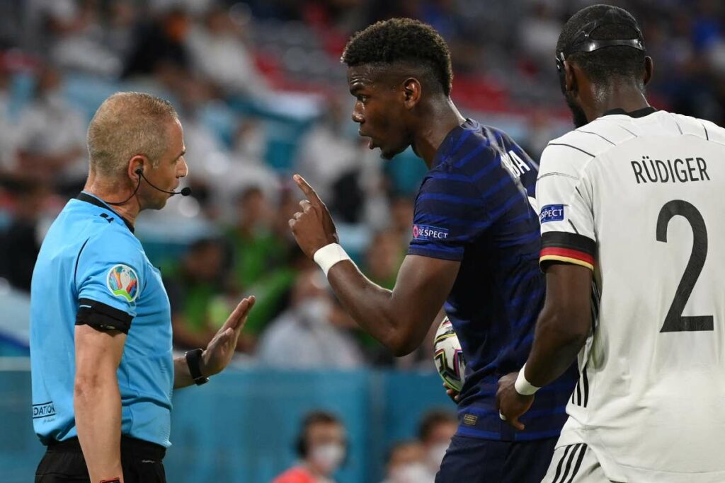 Paul Pogba complaining to the referee that he was bitten by Rudiger. 