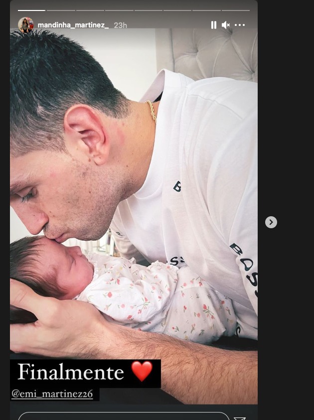 Emiliano Martinez kissing the forehead of his newborn baby. 