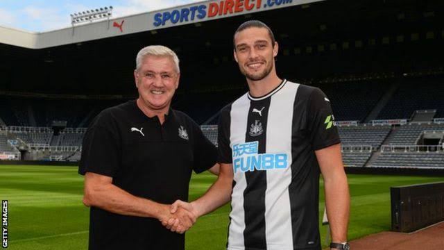  Carroll and the coach of Newcastle United Steve Bruce.