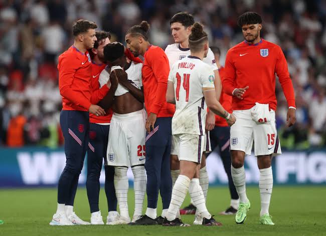 England players consoling Bukayo Saka after missing the last kick of the Euro 2020 final on July 11, 2021.