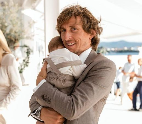 Luka Modric giving baby Ivan a tight hug.