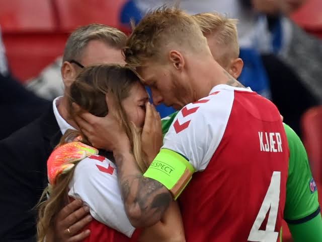 Denmark captain Simon Kjaer consoling the wife of Eriksen Sabrina Kvist when Eriksen collapsed on the pitch on June 12, 2021.
