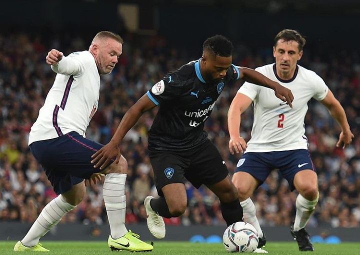 Patrice Evra taking on Wayne Rooney and Gary Neville during Soccer Aid 2021.