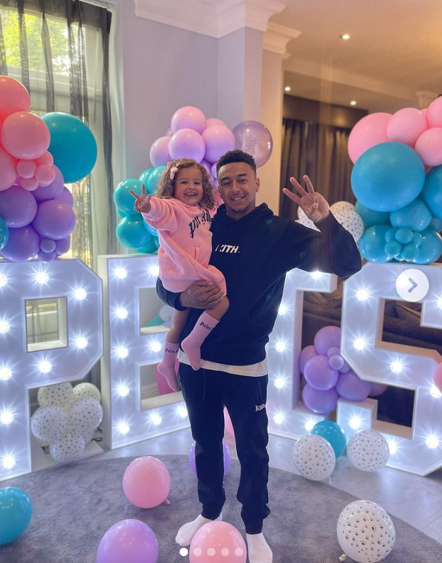 Jesse Lingard carrying his 3-year-old daughter Hope. 