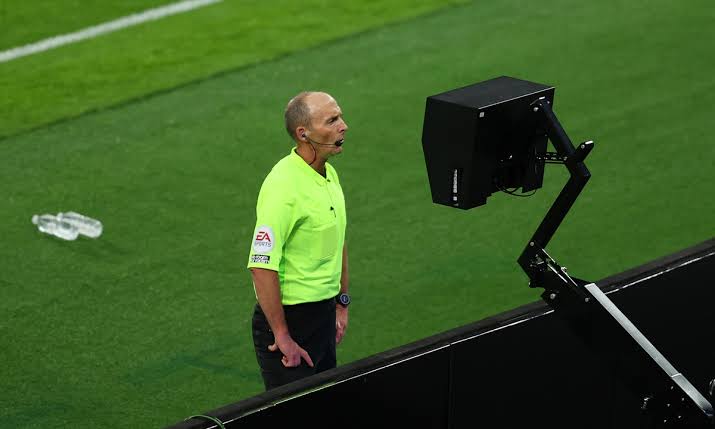 File photo of Referee Mike Dean checking the pitch side monitor.  