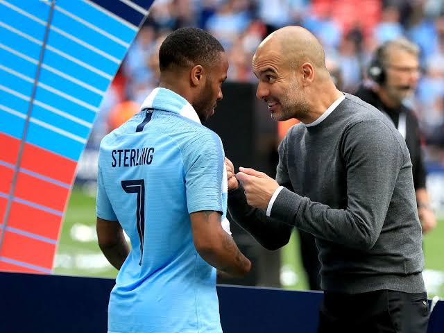 Pep Guardiola addressing Raheem Sterling during a league game. 
