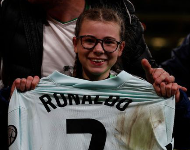 Addison Whelan displaying Cristiano Ronaldo jersey. 