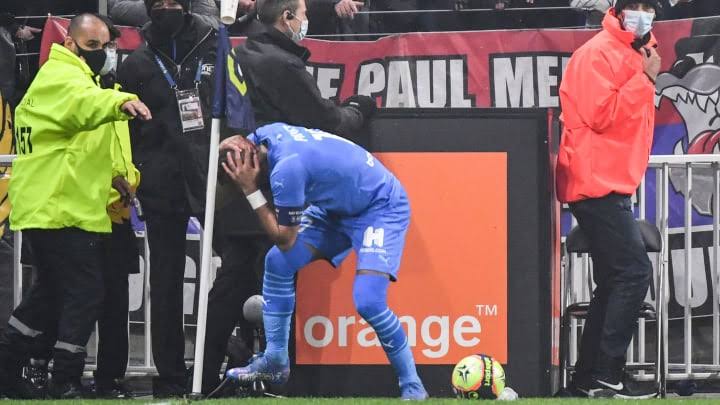 Dimitri Payet holds his head after he was hit by a plastic bottle on Sunday. 