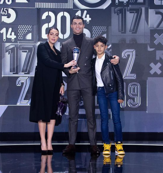 Cristiano Ronaldo, his fiancee Georgina Rodriguez, and Cristiano Jr. at the 2021 FIFA The Best Award. 