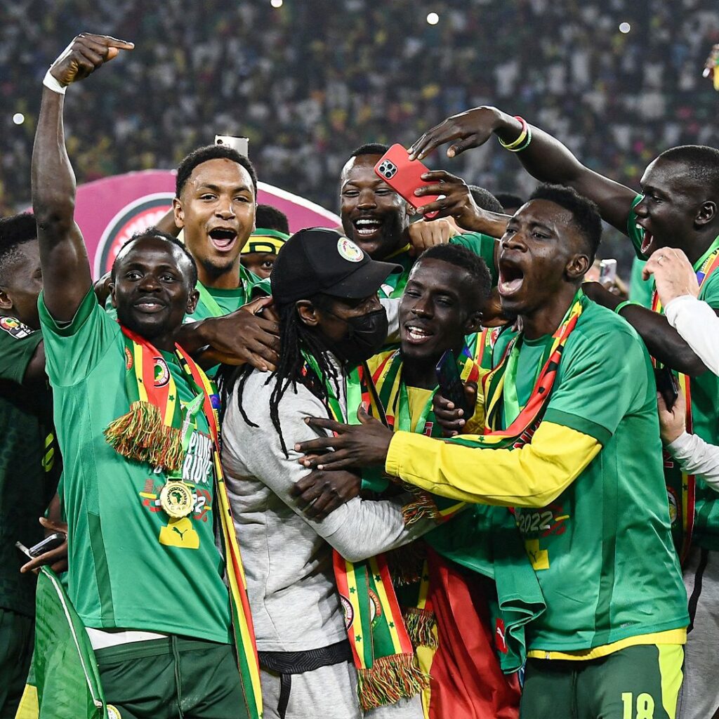 Senegal players celebrate with coach Aliou Cissé. 