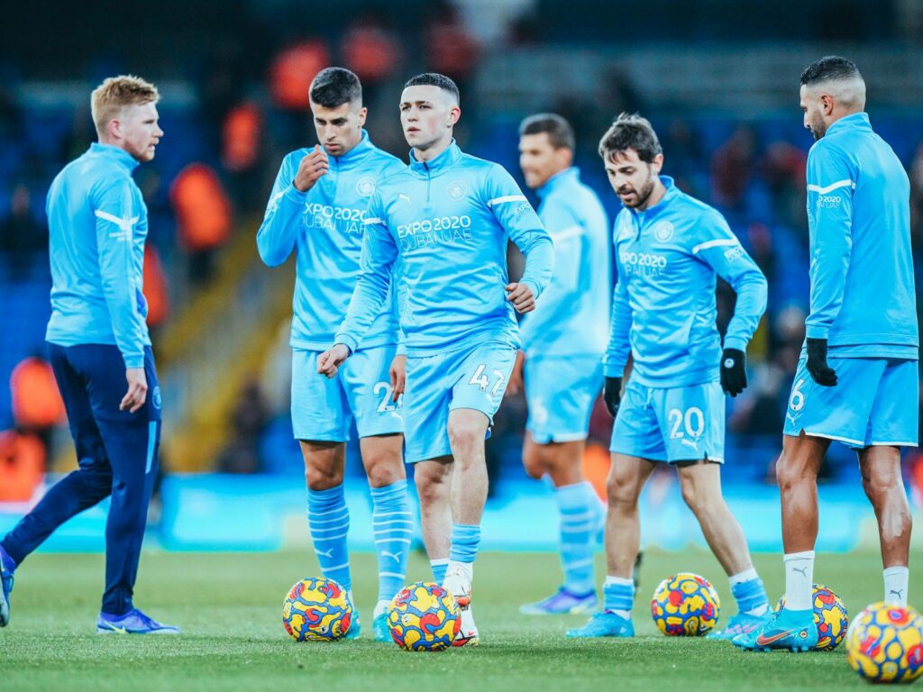 Manchester City players warming up for a game. 