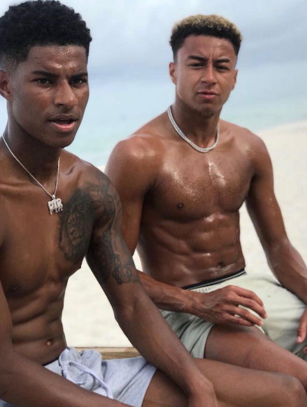 Marcus Rashford and Jesse Lingard chilling at a beach. 