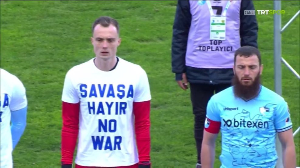 Aykut Demir (far right) refused to wear a "No War" t-shirt. 