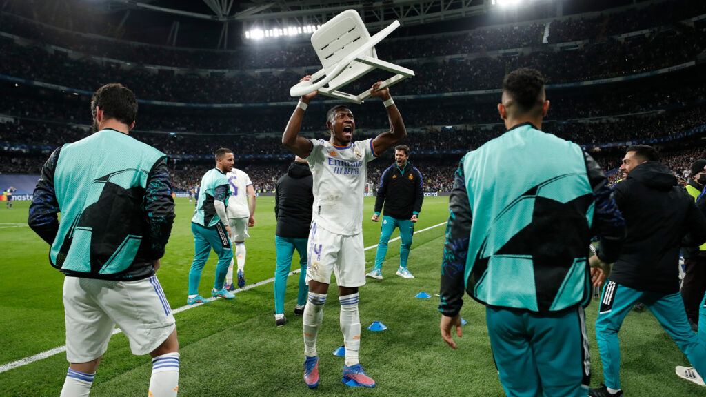 David Alaba celebrates by lifting a chair after Karim Benzema scored a winner against PSG on March 9.