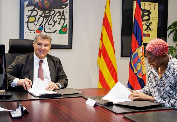 Asisat Oshoala poses with Barca president Joan Laporta as she extends her contract