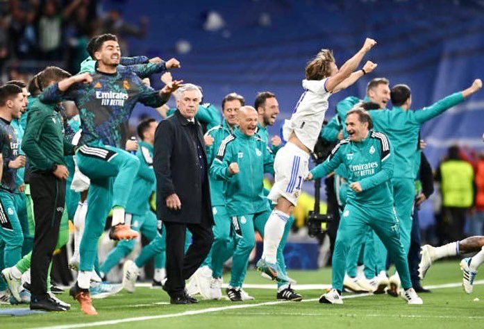 Real Madrid players celebrate their win over Manchester City around Ancelotti.
