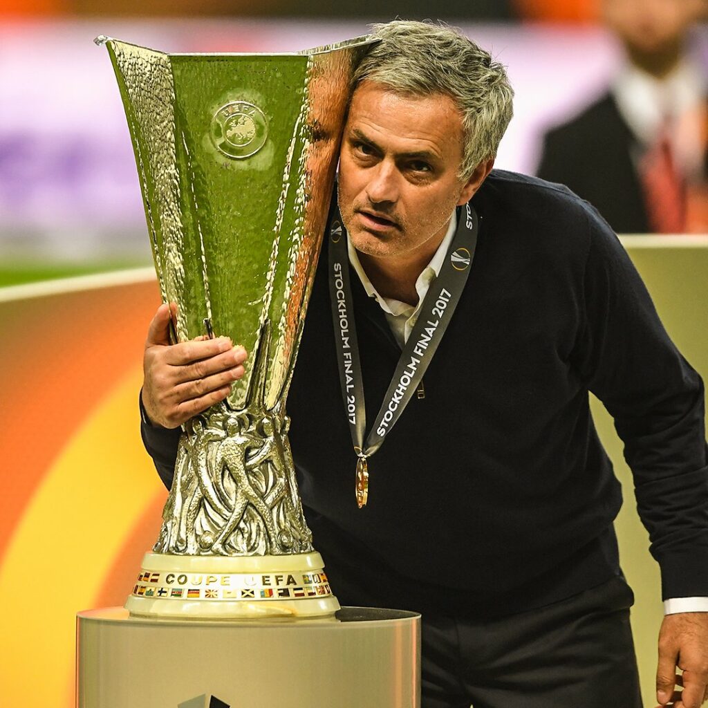 Jose Mourinho posing with the Europa League title. 