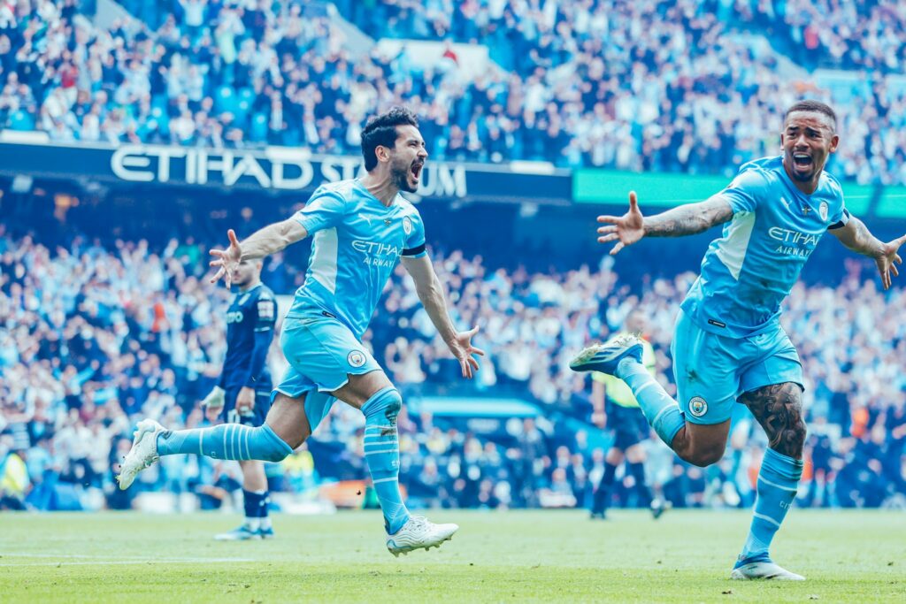 Ilkay Gundogan celebrates Manchester City's triumph alongside Gabriel Jesus.