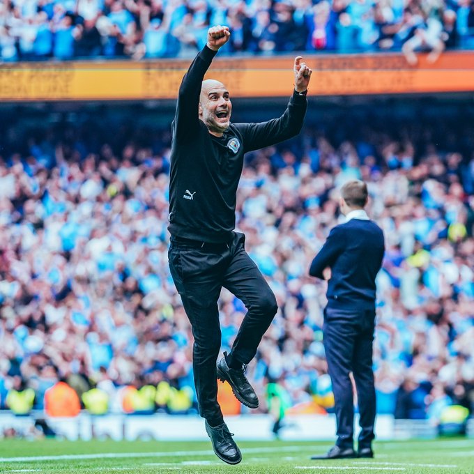 Coach Pep Guardiola celebrates Manchester City's Premier League triumph for the 2021-2022 season. 