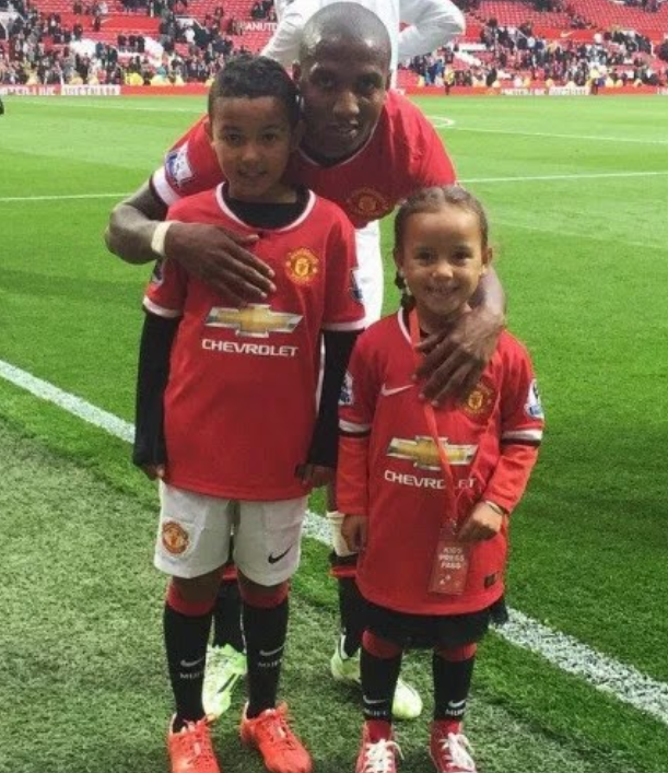 Tyler Young and Ellearna Young posing with their father at Old Trafford. 