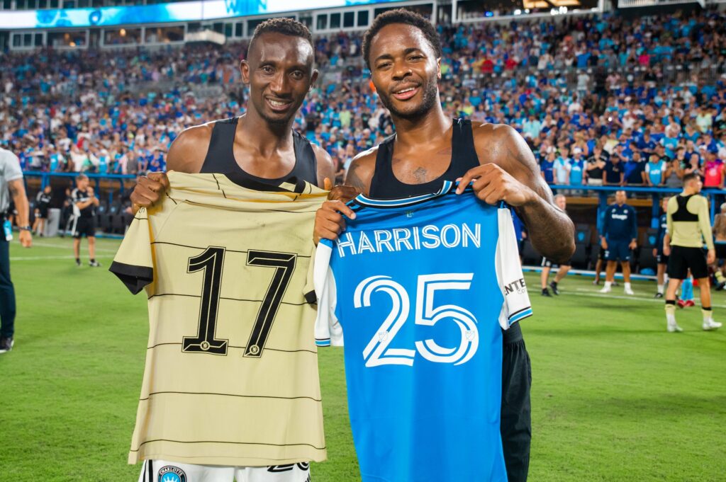 Chelsea's Raheem Sterling and Charlotte's King Harrison after the friendly game.