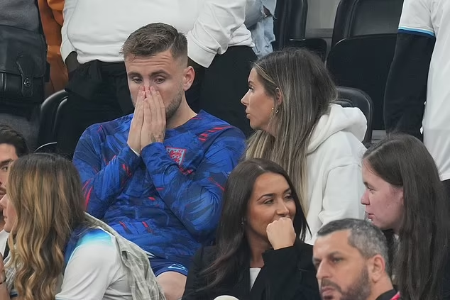 Weeping WAGs wipe away their tears as they console their heartbroken England following their 1-2 World Cup defeat to France