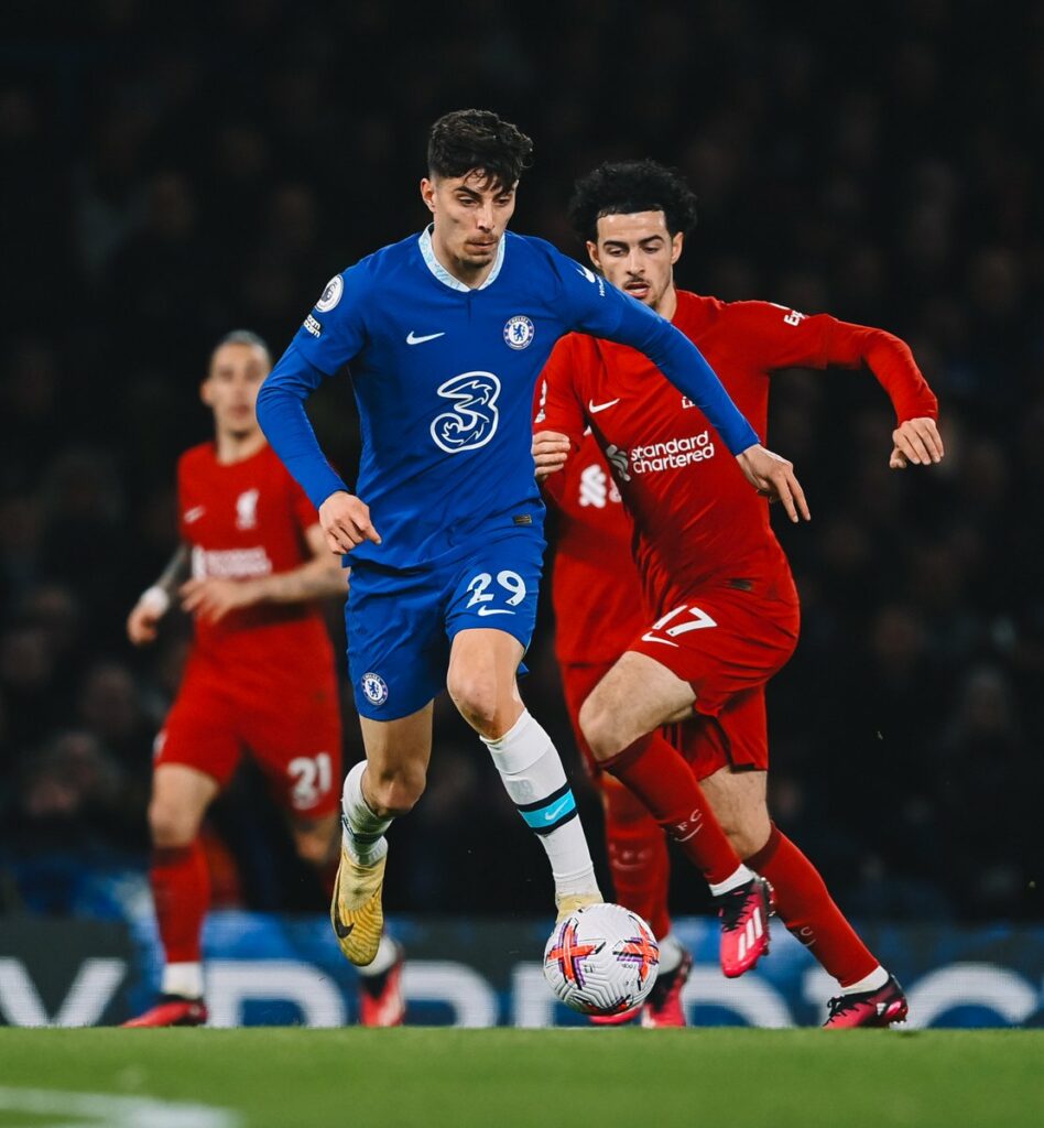 Kai Havertz in possession of the ball for Chelsea with Curtis Jones behind him

