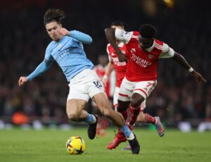 Jack Grealish and Bukayo Saka battling in the colours of their respective clubs